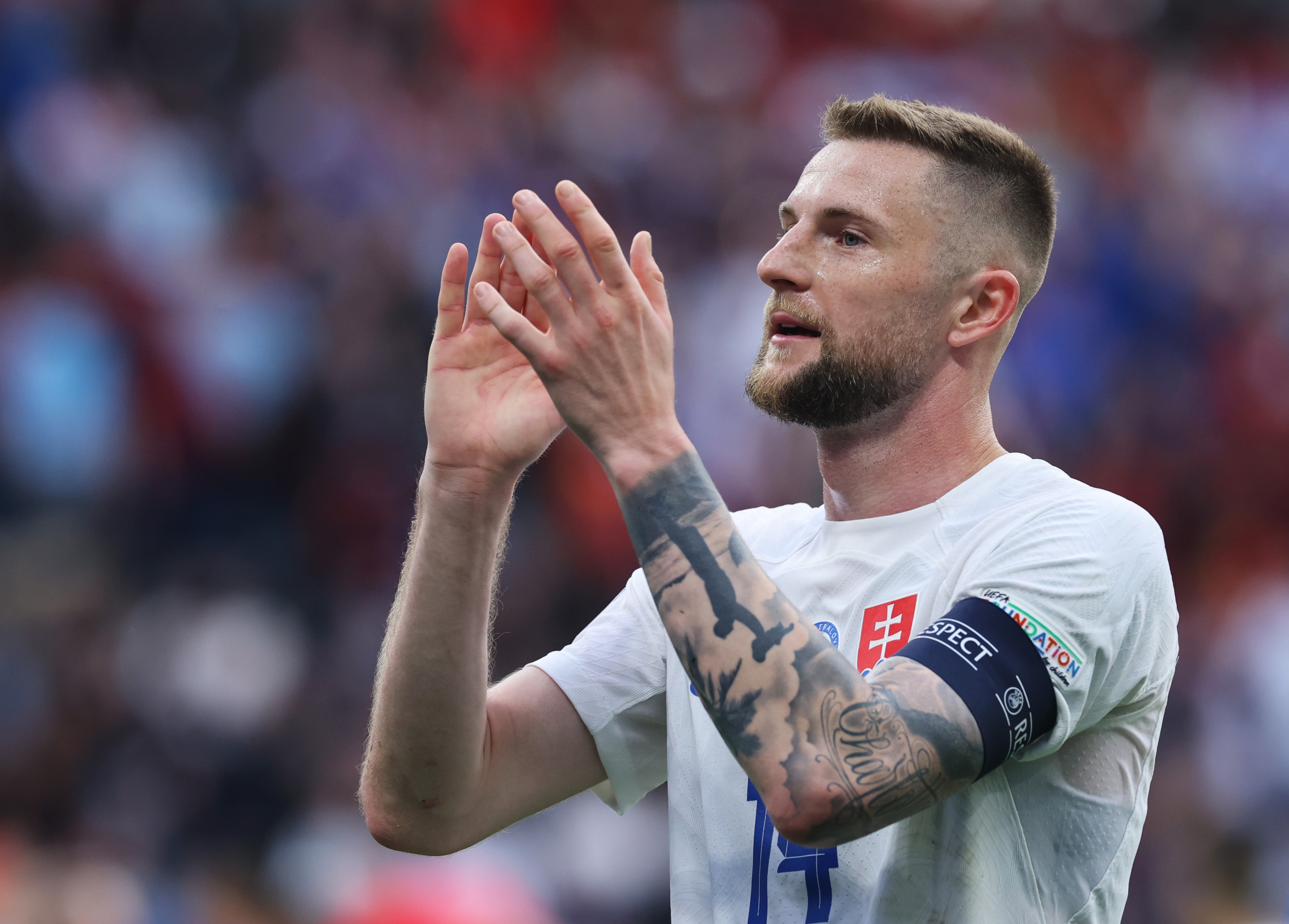 Milan Skriniar of Slovakia applauds the fans