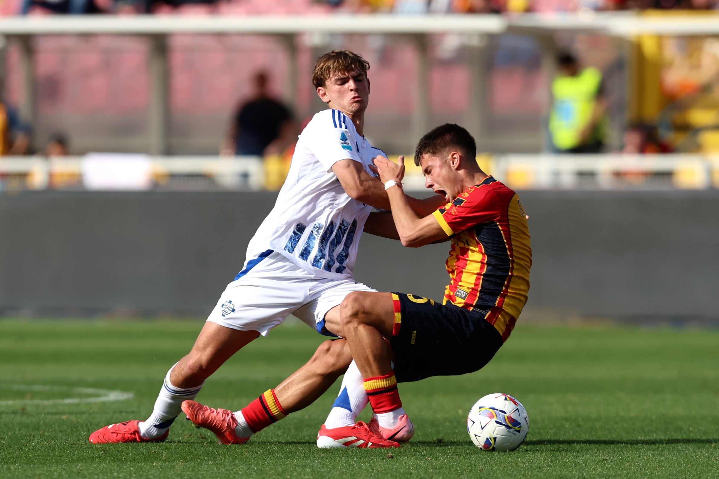 Medon Berisha of Lecce competes for the ball with Nicolas Paz of Como