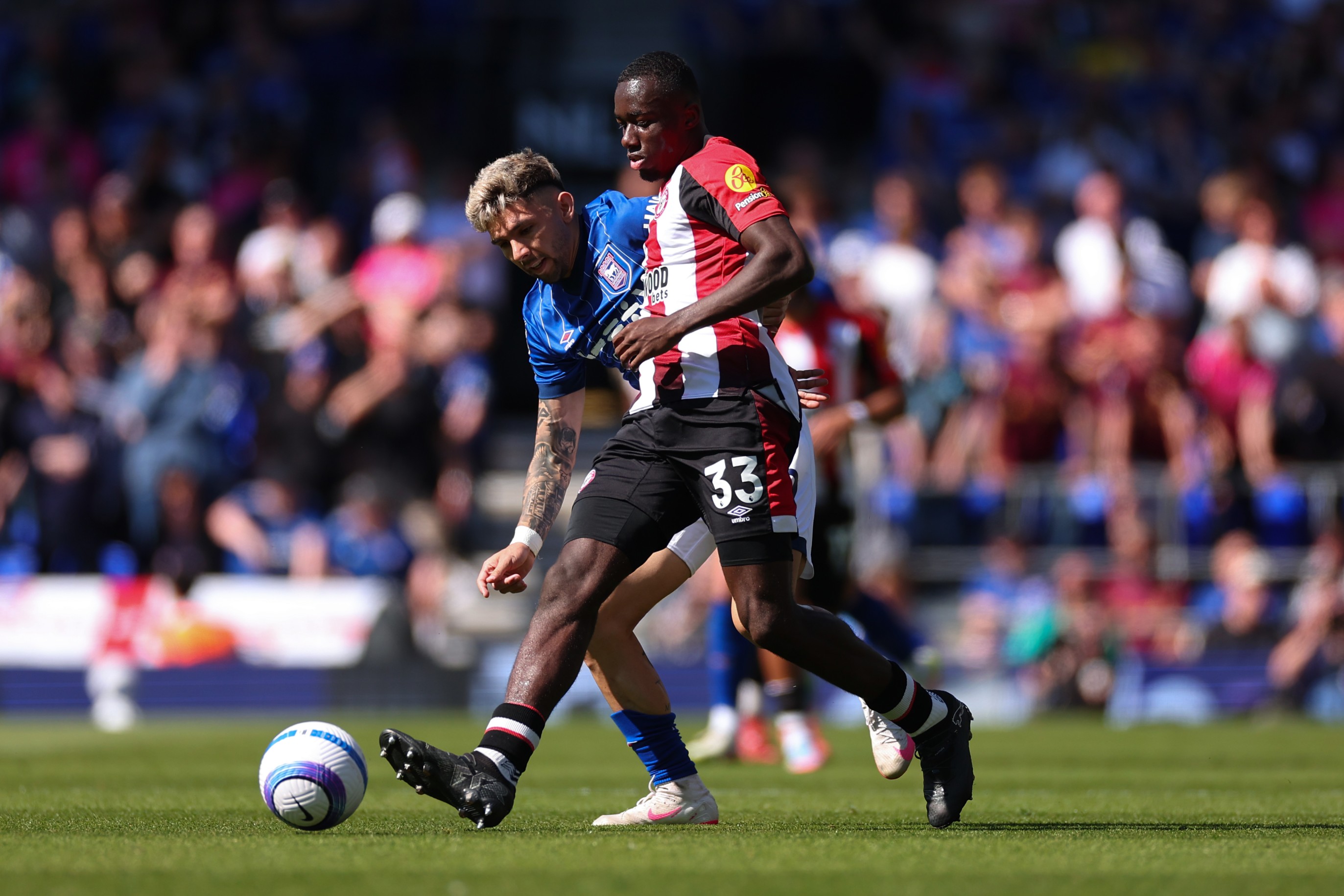 Michael Kayode of Brentford under pressure from Julio Enciso of Ipswich Town