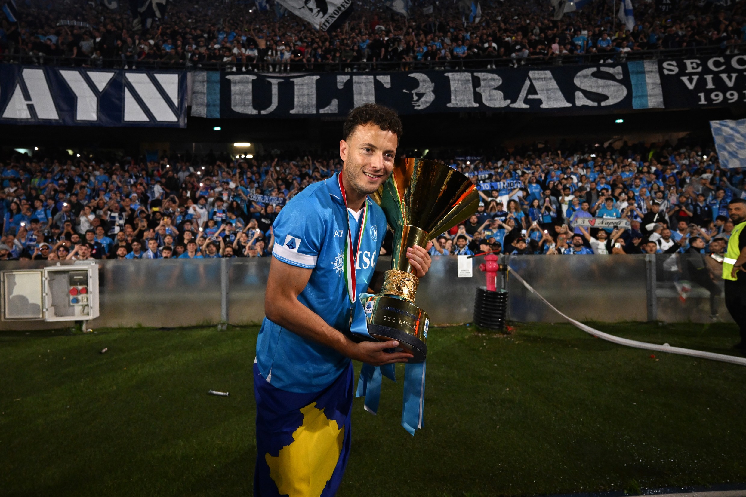 Amir Rrahmani of Napoli posing with the Serie A TIM Scudetto title trophy