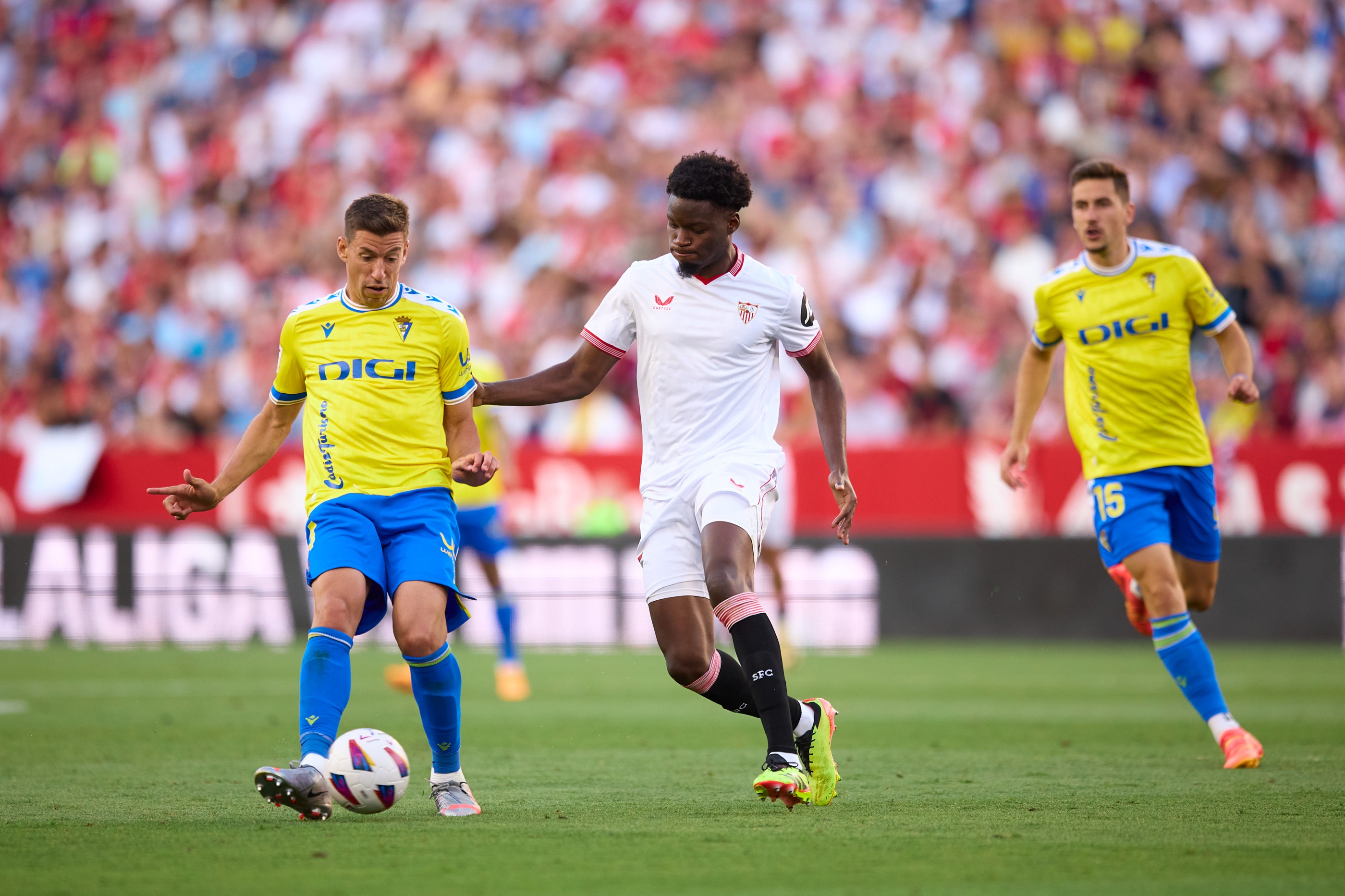 Ruben Alcaraz of Cadiz CF competes for the ball with Lucien Agoume of Sevilla FC