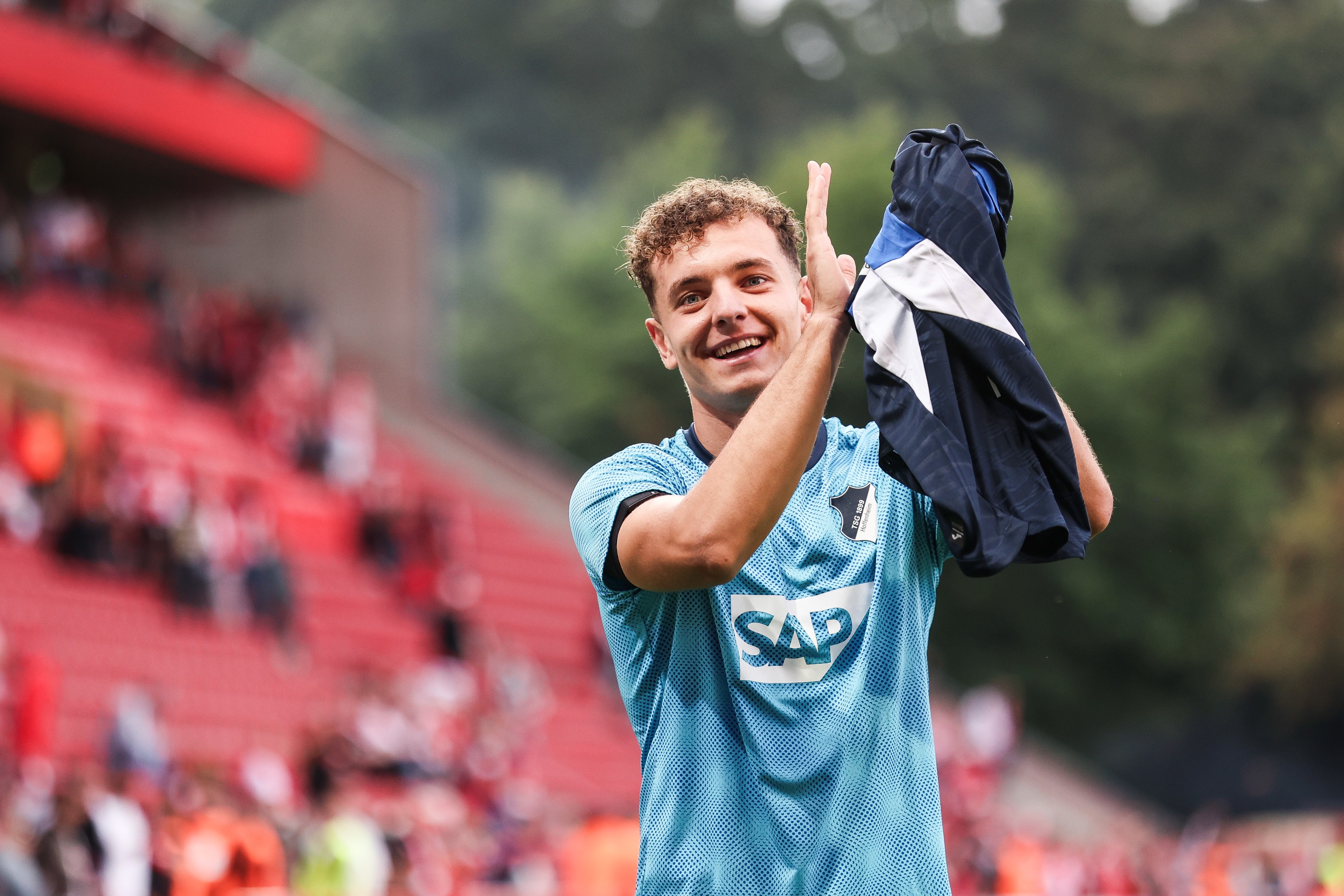 Fisnik Asllani of TSG Hoffenheim shows appreciation to the fans