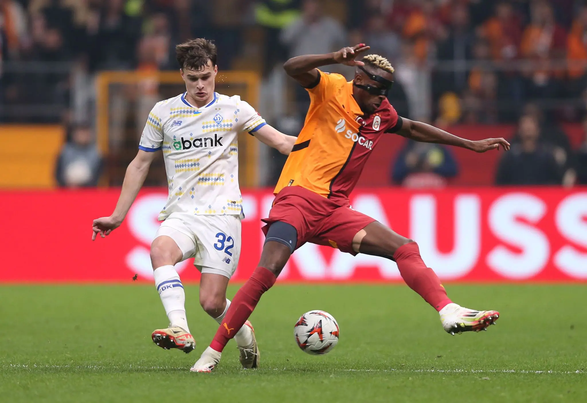 Victor Osimhen of Galatasaray is challenged by Taras Mykhavko
